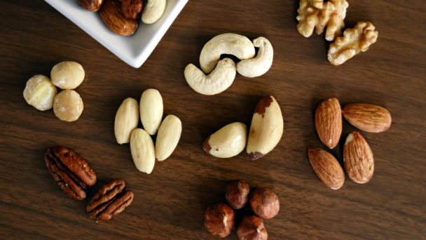 variety-of-brown-nuts-on-brown-wooden-panel-high-angle-photo