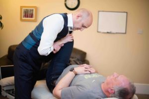 Chiropractor administering treatment to a patient's leg