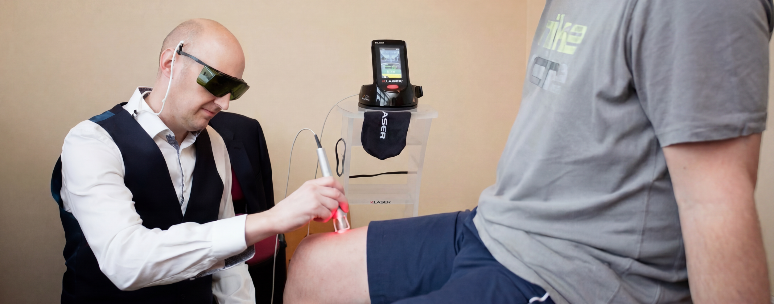 Chiropractor using laser therapy on patient