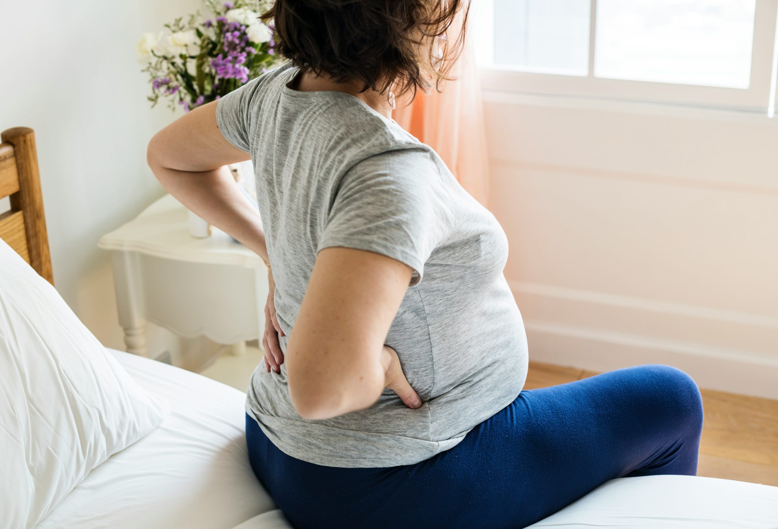 Pregnant lady holding back